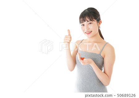 Young lady taking medicine · supplement Young lady taking medicine · supplement 50689126