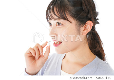 Young lady taking medicine · supplement Young lady taking medicine · supplement 50689140