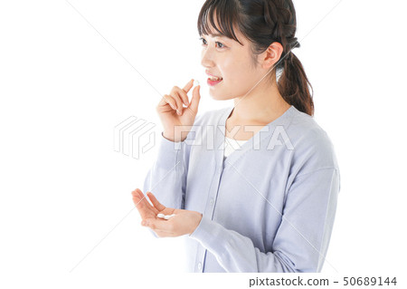Young lady taking medicine · supplement Young lady taking medicine · supplement 50689144