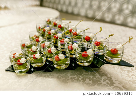 the buffet at the reception. Glasses of wine the buffet at the reception. Glasses of wine 50689315