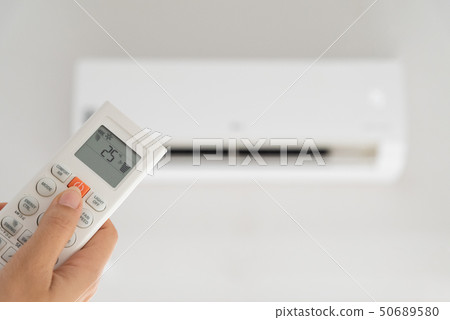Woman hand holding air remote controller Woman hand holding air remote controller 50689580