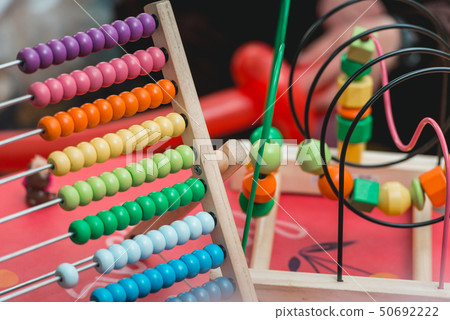 Colourful wooden abacus. Educational concept for kids. Learing to count. Wooden Toys ,intelligent Colourful wooden abacus. Educational concept for kids. Learing to count. Wooden Toys ,intelligent 50692222