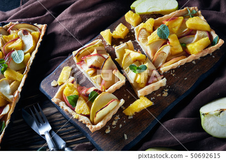 french pineapple and apple sweet tart, close-up 50692615