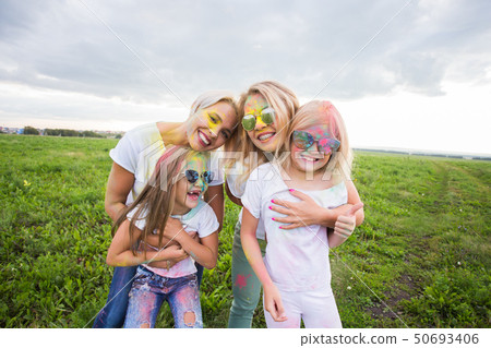 Festival of Holi, friendship and holidays concept - young female people on the color dancing and 50693406