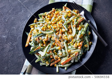 cucumber corn cheese salad on a black plate cucumber corn cheese salad on a black plate 50694338