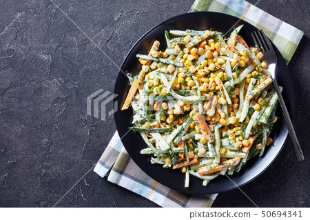 cucumber corn cheese salad on a black plate cucumber corn cheese salad on a black plate 50694341