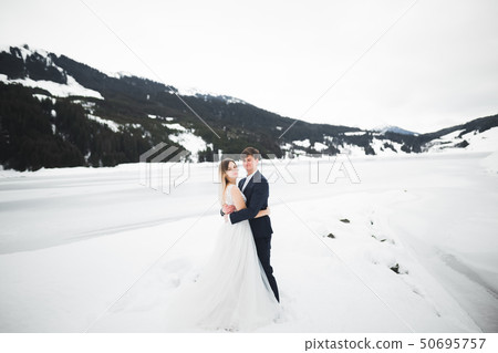 Loving husband and woman on the background of the mountains. Loving couple emotionally spends time Loving husband and woman on the background of the mountains. Loving couple emotionally spends time 50695757