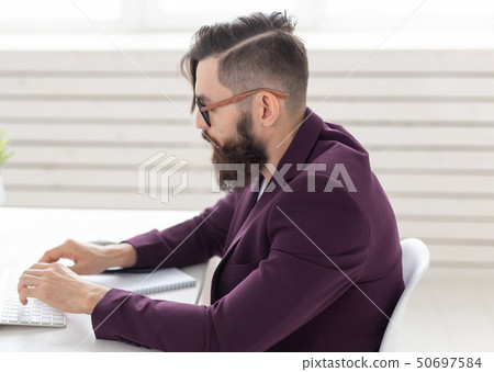 People and technology concept - Side view portrait of handsome man dressed in purple jacket working People and technology concept - Side view portrait of handsome man dressed in purple jacket working 50697584