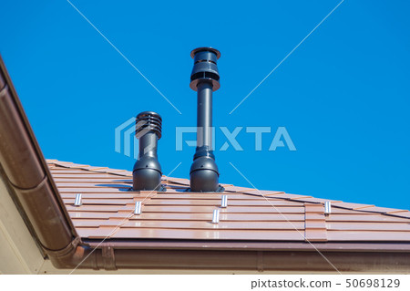 Exhaust pipe on the private house roof Exhaust pipe on the private house roof 50698129