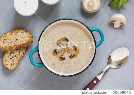 Mushroom champignon cream soup with toast on grey concrete table. View from above. Mushroom champignon cream soup with toast on grey concrete table. View from above. 50699040