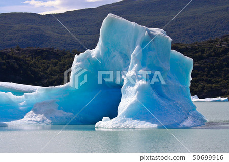 Large blue bright icebergs float on the waters of Lago Argentino lake, El Calafate, Argentina in 50699916
