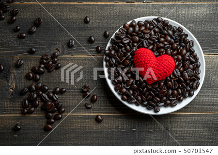 red heart on a lot of roasted coffee beans red heart on a lot of roasted coffee beans 50701547
