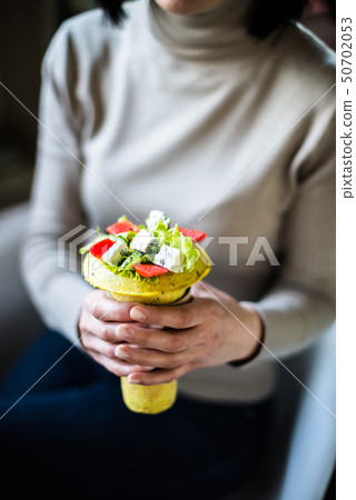 Woman holding healthy salad in her hands Woman holding healthy salad in her hands 50702053