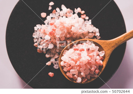 Pink salt from Bolivian in spoon on ceramic plate 50702644