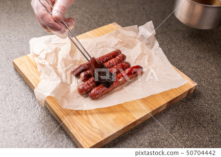 Food and delicious concept - Horse meat sausage covered with ketchup Food and delicious concept - Horse meat sausage covered with ketchup 50704442