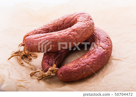 Food, meat and delicious concept - sausages made with horse meat on the table 50704472