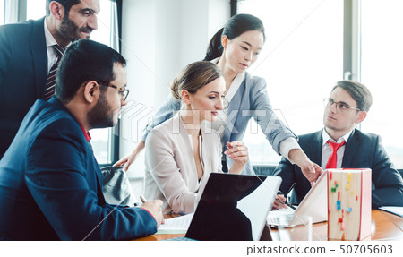 Business advisors structuring a deal Business advisors structuring a deal 50705603