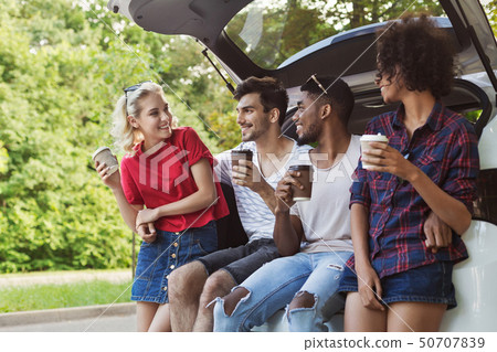 Happy travelers sitting in car back 50707839