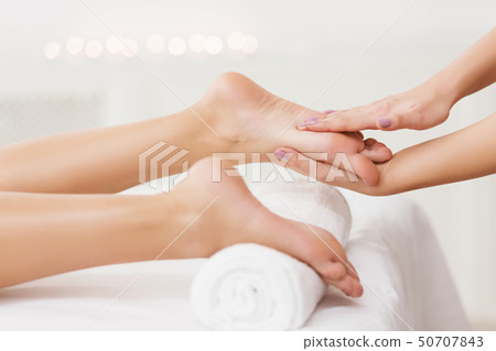 Spa Concept. Masseur Massaging Female Feet Closeup Spa Concept. Masseur Massaging Female Feet Closeup 50707843