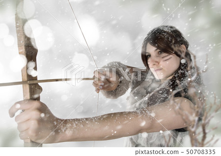 Beautiful young Amazon female warrior posing in a fighting stance with a bow. Beautiful young Amazon female warrior posing in a fighting stance with a bow. 50708335