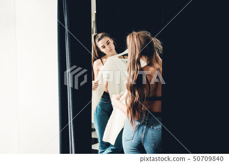 young beautiful woman shopping, in a fitting room young beautiful woman shopping, in a fitting room 50709840