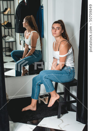 Shot of a beautiful woman in the fitting room. 50709849