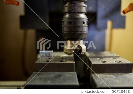 Part machining at machining center 50710438