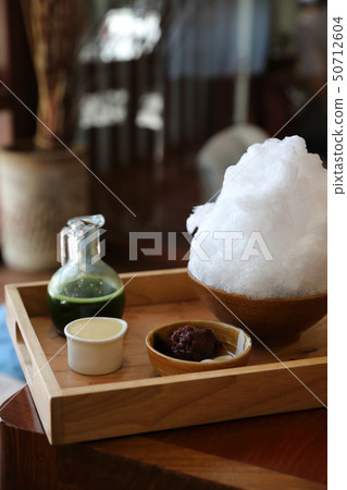 Delicious Japanese sweet shaved ice green tea on wooden table in japanese cafe 50712604