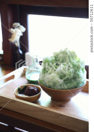 Delicious Japanese sweet shaved ice green tea on wooden table in japanese cafe 50712611