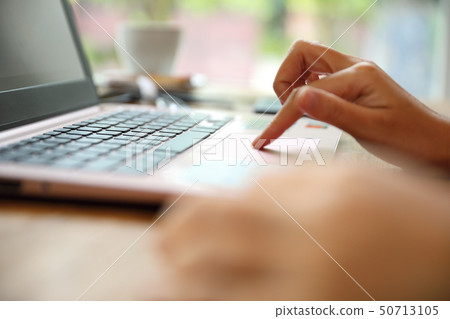 Woman hand working at coffee shop hand on keyboard with close up Woman hand working at coffee shop hand on keyboard with close up 50713105