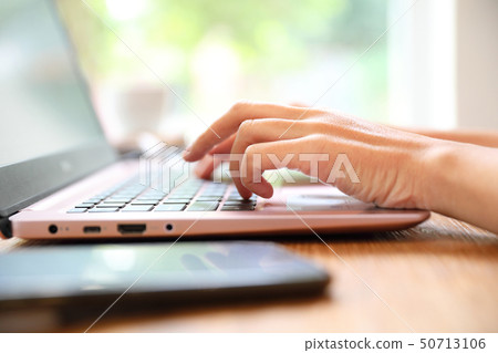 Woman hand working at coffee shop hand on keyboard with close up Woman hand working at coffee shop hand on keyboard with close up 50713106