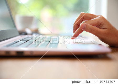 Woman hand working at coffee shop hand on keyboard with close up Woman hand working at coffee shop hand on keyboard with close up 50713107