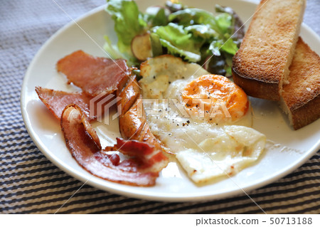 English breakfast fried egg bacon sausage bread and salad English breakfast fried egg bacon sausage bread and salad 50713188