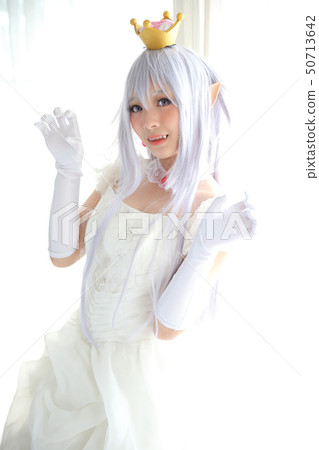 Portrait of vampire dracula young woman dress in white tone room halloween concept 50713642