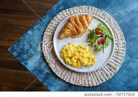 Breakfast with croissant, scrambled egg, and salad Breakfast with croissant, scrambled egg, and salad 50717020