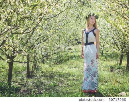 Young beautiful dreaming woman in spring blossom trees. Young beautiful dreaming woman in spring blossom trees. 50717968