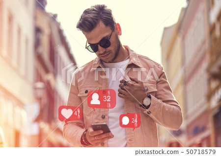 Young Adult Man Using Social Media on Smartphone - 50718579