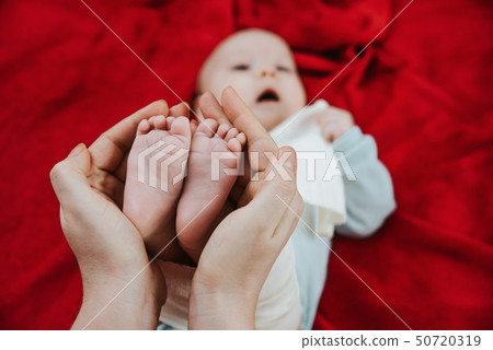 closeup on small feet of a newborn baby closeup on small feet of a newborn baby 50720319