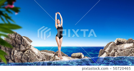 Young sporty woman in black swimwear ready to jump in water. Young sporty woman in black swimwear ready to jump in water. 50720465