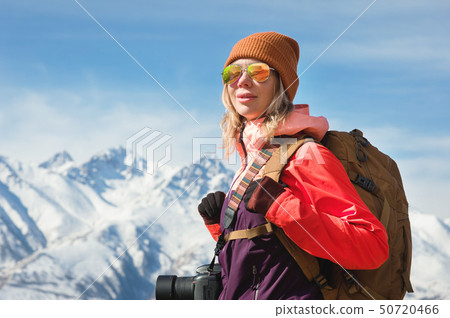 Portrait of photographer hipster tourist girl with a camera in sunglasses and a hat against the Portrait of photographer hipster tourist girl with a camera in sunglasses and a hat against the 50720466
