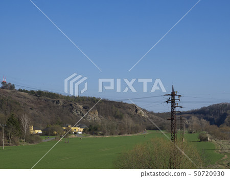 Green meadow and rocks in city Beroun, early spring, blue sky. Czech Republic Green meadow and rocks in city Beroun, early spring, blue sky. Czech Republic 50720930