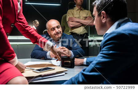 Man thinking about his statement and the criminal charge during interrogation 50722999