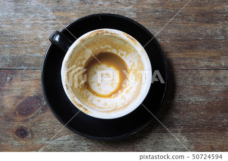Empty mug of coffee latte on vintage wooden table 50724594