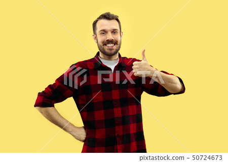 Half-length close up portrait of young man on yellow background. Half-length close up portrait of young man on yellow background. 50724673