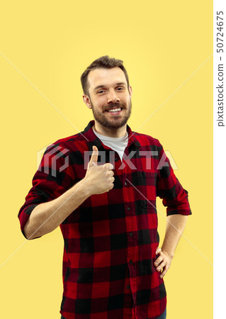 Half-length close up portrait of young man on yellow background. Half-length close up portrait of young man on yellow background. 50724675