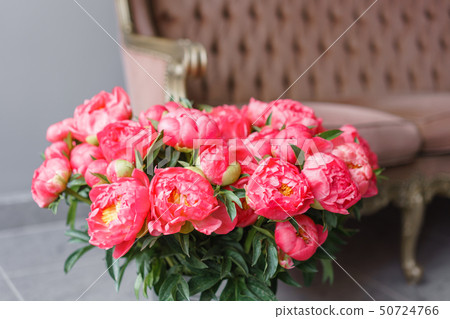 Coral peonies in a metal vase. Beautiful peony flower for catalog or online store. Floral shop 50724766