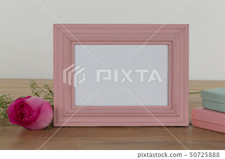 Rose flower, empty photo frame and gift boxes 50725888