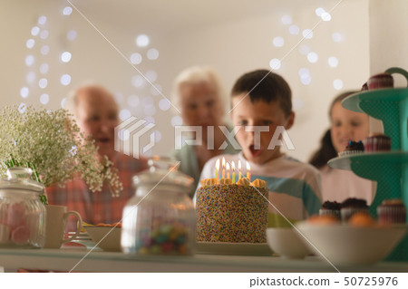 Multi-generation family celebrating birthday of grandson 50725976