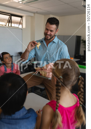 Male teacher explaining anatomical model in classroom 50726134