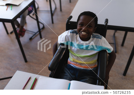 Disable schoolboy looking at camera in classroom Disable schoolboy looking at camera in classroom 50726235